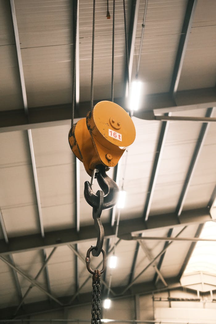 Mastering the First Impression: Your intriguing post title goes here Close-up of a yellow crane hook in an industrial warehouse in Konya, Türkiye.